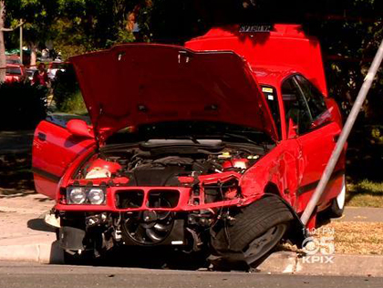This red BMW ends up crashing into a pole on Leigh Avenue in San Jose after an apparent street race on April 23, 2013. A second car crashed into a nearby home, injuring several people. (CBS)