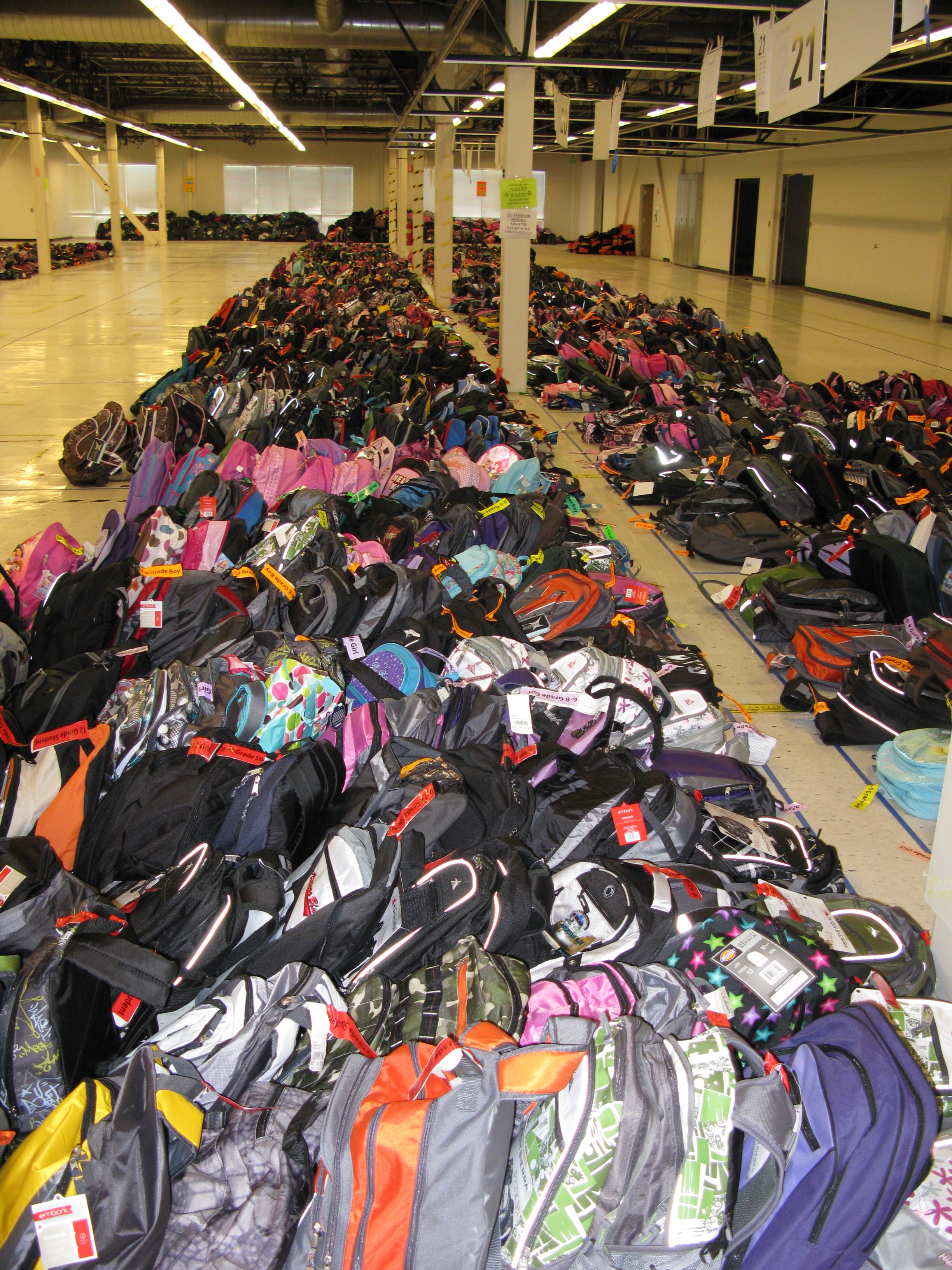 Thousands of backpacks filled with school supplies are collected in a warehouse, ready for distribution. (Family Giving Tree)