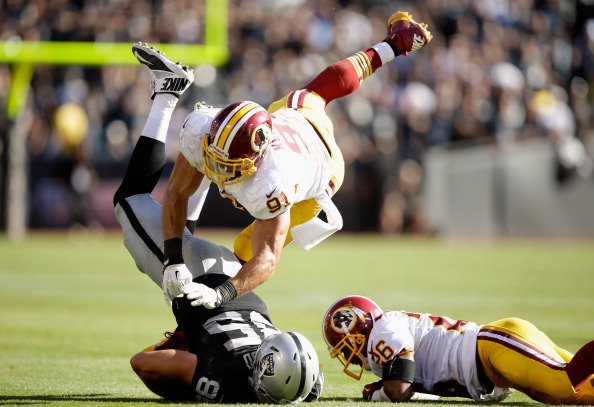 OAKLAND, CA - SEPTEMBER 29:  Ryan Kerrigan #91 of the Washington Redskins tackles Jeron Mastrud #85 of the Oakland Raiders at O.co Coliseum on September 29, 2013 in Oakland, California.  (Photo by Ezra Shaw/Getty Images)
