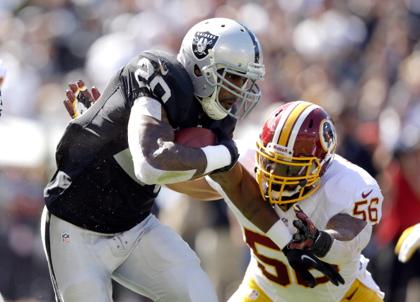 OAKLAND, CA - SEPTEMBER 29:  Darren McFadden #20 of the Oakland Raiders is tackled by Perry Riley #56 of the Washington Redskins at O.co Coliseum on September 29, 2013 in Oakland, California.  (Photo by Ezra Shaw/Getty Images) 