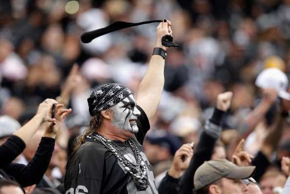 OAKLAND, CA - OCTOBER 27: An Oakland Raiders fan cheers on his team during their game against the Pittsburgh Steelers at O.co Coliseum on October 27, 2013 in Oakland, California. (Photo by Ezra Shaw/Getty Images)