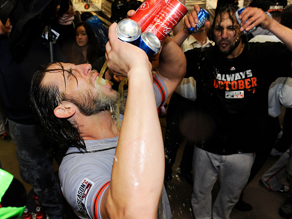 Madison Bumgarner #40 of the San Francisco Giants celebrates in the locker room after they defeated the Pittsburgh Pirates 8 to 0 during the National League Wild Card game at PNC Park on October 1, 2014 in Pittsburgh, Pennsylvania.  (Photo by Jason Miller/Getty Images)