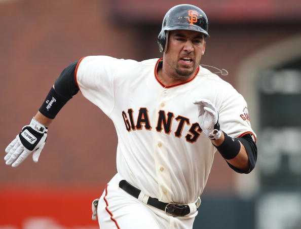 Travis Ishikawa #10 of the San Francisco Giants runs to third on his way to a three run triple in the first inning against the Milwaukee Brewers during Opening Day of the Major League Baseball season on April 7, 2009 at AT&T Park in San Francisco, California.  (Photo by Jed Jacobsohn/Getty Images)