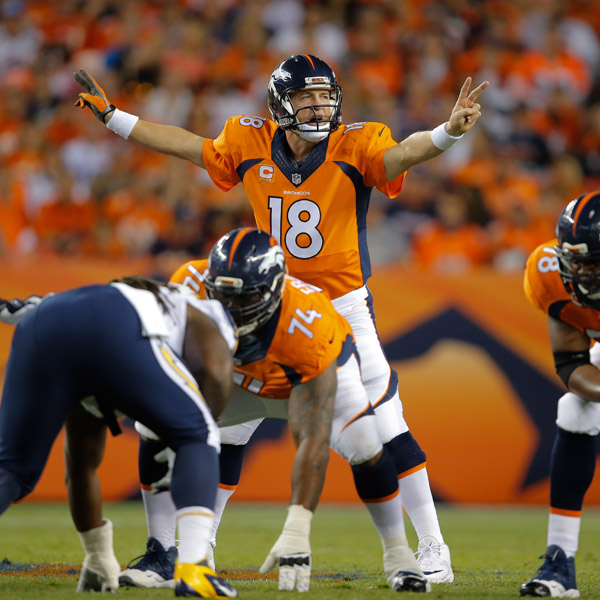 DENVER, CO - OCTOBER 23: Quarterback Peyton Manning #18 of the Denver Broncos runs the offense against the San Diego Chargers during a game at Sports Authority Field at Mile High on October 23, 2014 in Denver, Colorado.