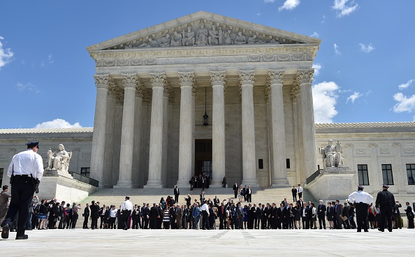 Gay couples and their legal teams, defending same-sex marriages cheer as they leave the US Supreme Court. (MLADEN ANTONOV/AFP/Getty Images)