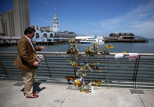 A well-wisher drops off flowers at the site where 32-year-old Kathryn Steinle was killed on July 6, 2015 in San Francisco, California. According to police, Steinle was shot and killed by Francisco Sanchez as she walked with her father on San Francisco's Pier 14 on July 1. Sanchez had been previously deported five times.  (Photo by Justin Sullivan/Getty Images)