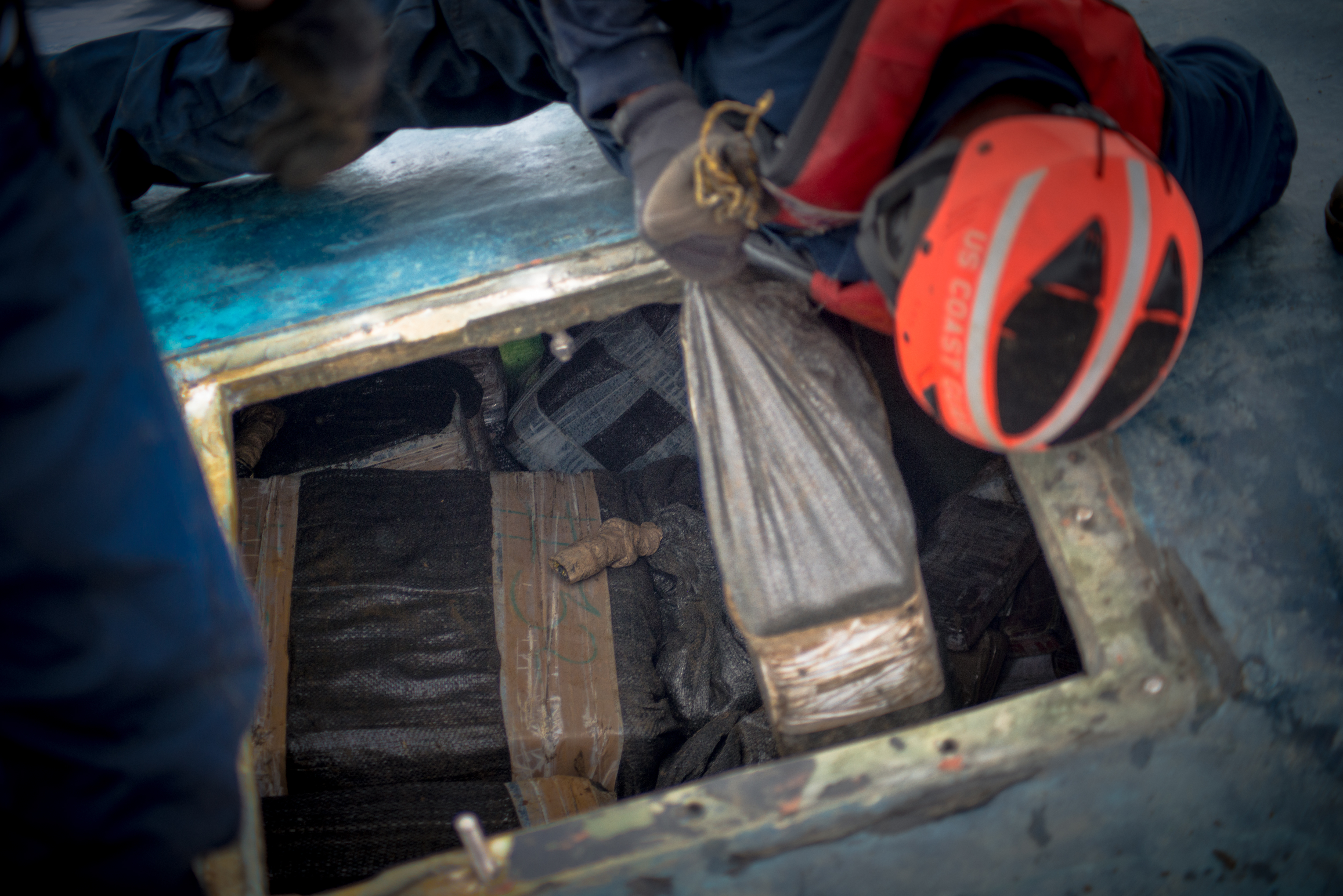 A Coast Guard Cutter Stratton boarding team seizes cocaine bales from a self-propelled semi-submersible interdicted in international waters off the coast of Central America, July 19, 2015. The Coast Guard recovered more than 6 tons of cocaine from the 40-foot vessel. (Coast Guard photo courtesy of Petty Officer 2nd Class LaNola Stone)
