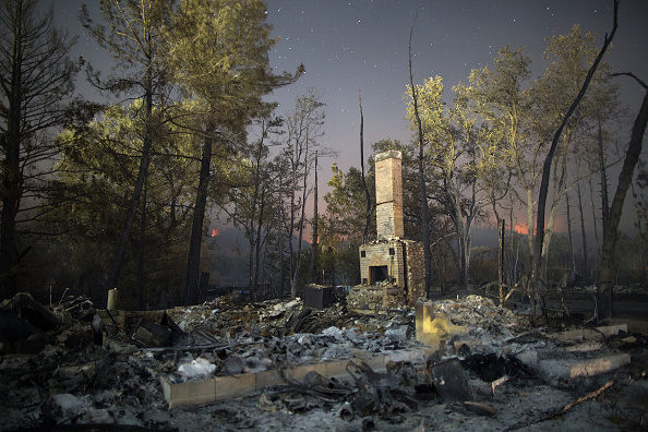 The ruins of a home that burned in the Valley Fire are seen on September 15, 2015 in Middletown, California. The 104-square-mile fire is only 15 percent contained and has destroyed 585 homes so far and hundreds of other structures. (Photo by David McNew/Getty Images)