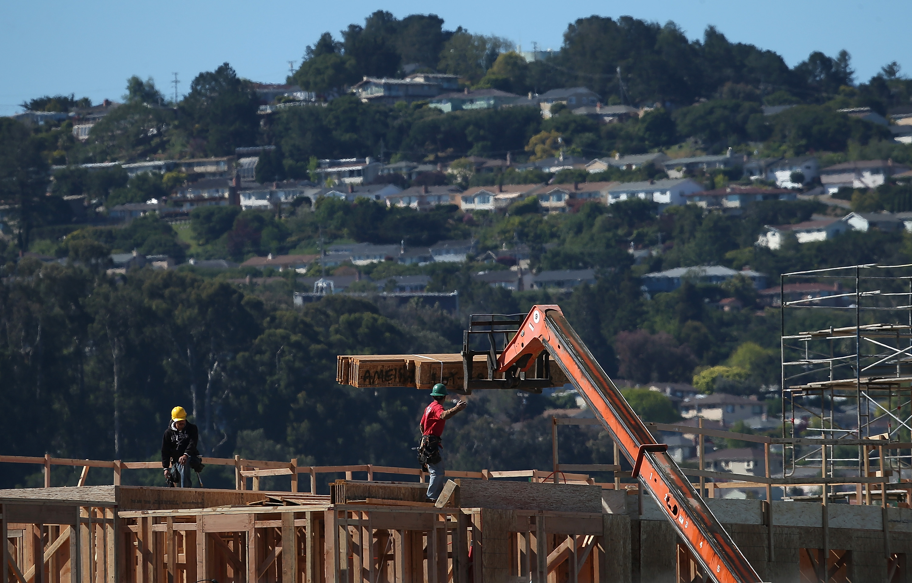 Workers build apartment homes at housing development under construction San Mateo, California.  (Photo by Justin Sullivan/Getty Images)