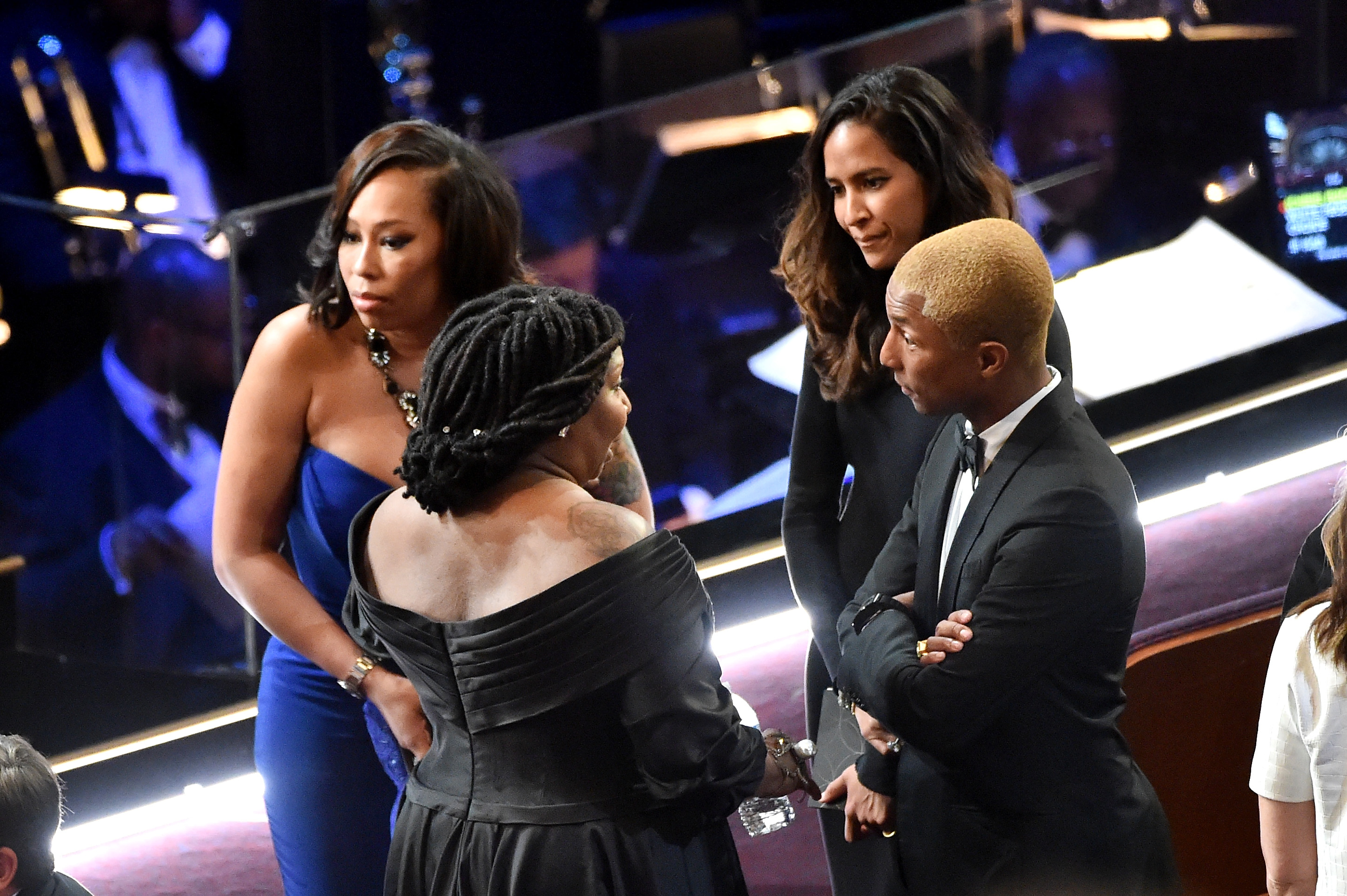  (L-R) Actor Whoopi Goldberg, musician Pharrell Williams and Helen Lasichanh in the audience during the 88th Annual Academy Awards. (Photo by Kevin Winter/Getty Images)
