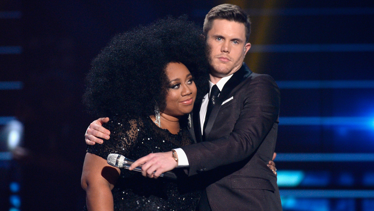 HOLLYWOOD, CALIFORNIA - APRIL 07:  American Idol Season 15 winner Trent Harmon (R) and finalist La'Porsha Renae embrace onstage during FOX's 