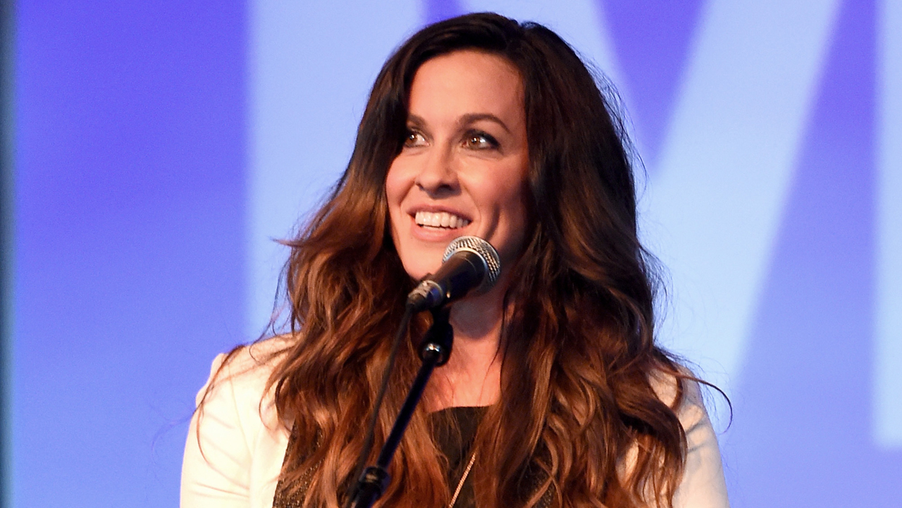 Alanis Morissette bares her huge baby bump as she poses 