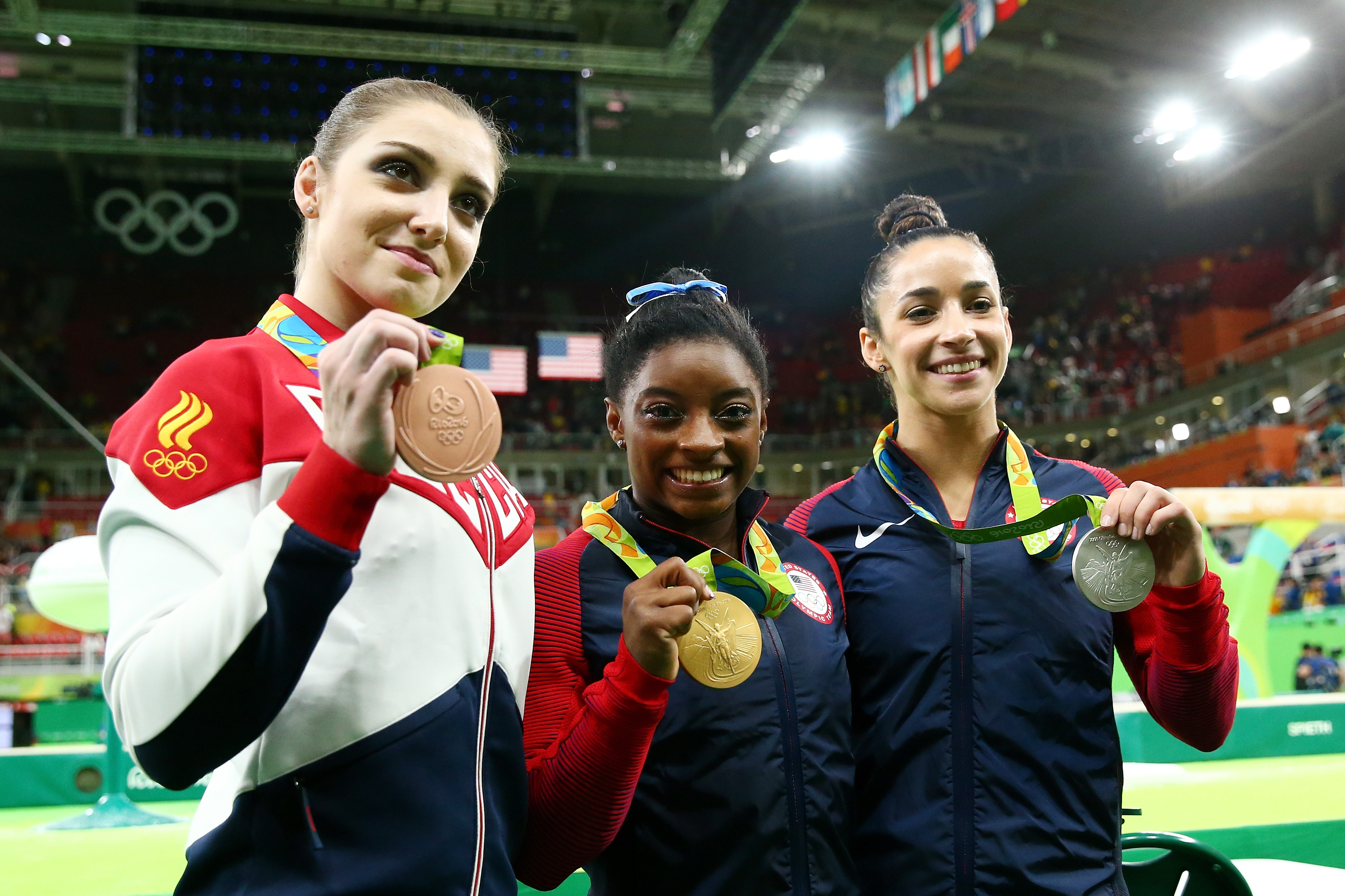 (L to R) Bronze medalist Aliya Mustafina of Russia, gold medalist Simone Biles of the United States and silver medalist Alexandra Raisman of the United States pose for photographs after the medal ceremony for the Women's Individual All Around on Day 6 of the 2016 Rio Olympics.  (Photo by Alex Livesey/Getty Images)