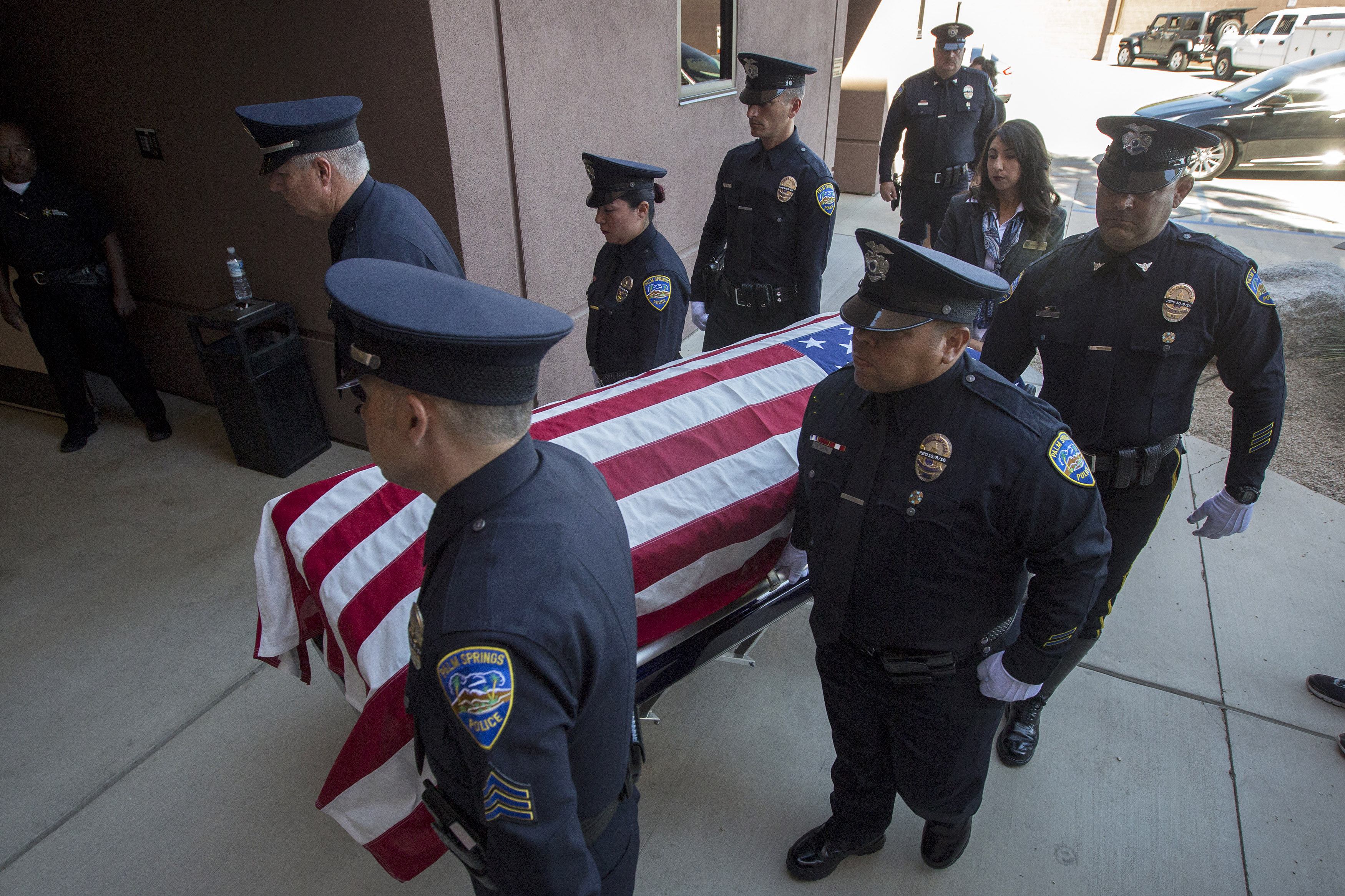 The casket of slain police officer Jose Gilbert Vega is carried by fellow officers at a joint memorial service for fallen Palm Springs Police officers Jose Gilbert Vega and Lesley Zerebny at the Palm Springs Convention Center on October 18, 2016. (Photo by David McNew/Getty Images)