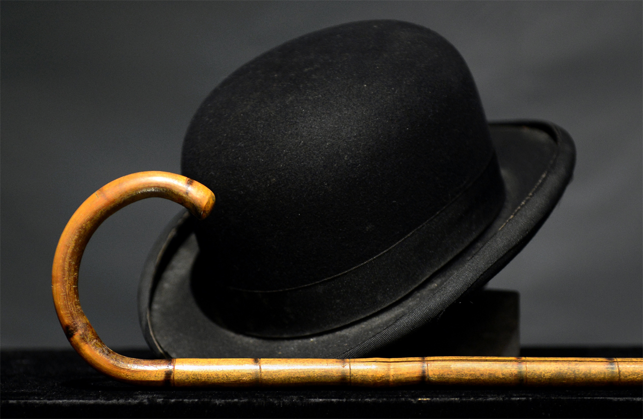 Charlie Chaplain's iconic bowler hat and cane are displayed during a press preview at auction house Bonham's in Hollywood, California, on November 15, 2012.  Chaplin's hat and cane are to go under the hammer in Los Angeles this weekend as part of an auction which also includes a John Lennon nude drawing of himself and Yoko Ono. The hat and cane trademark of Chaplin's Little Tramp character  are in 