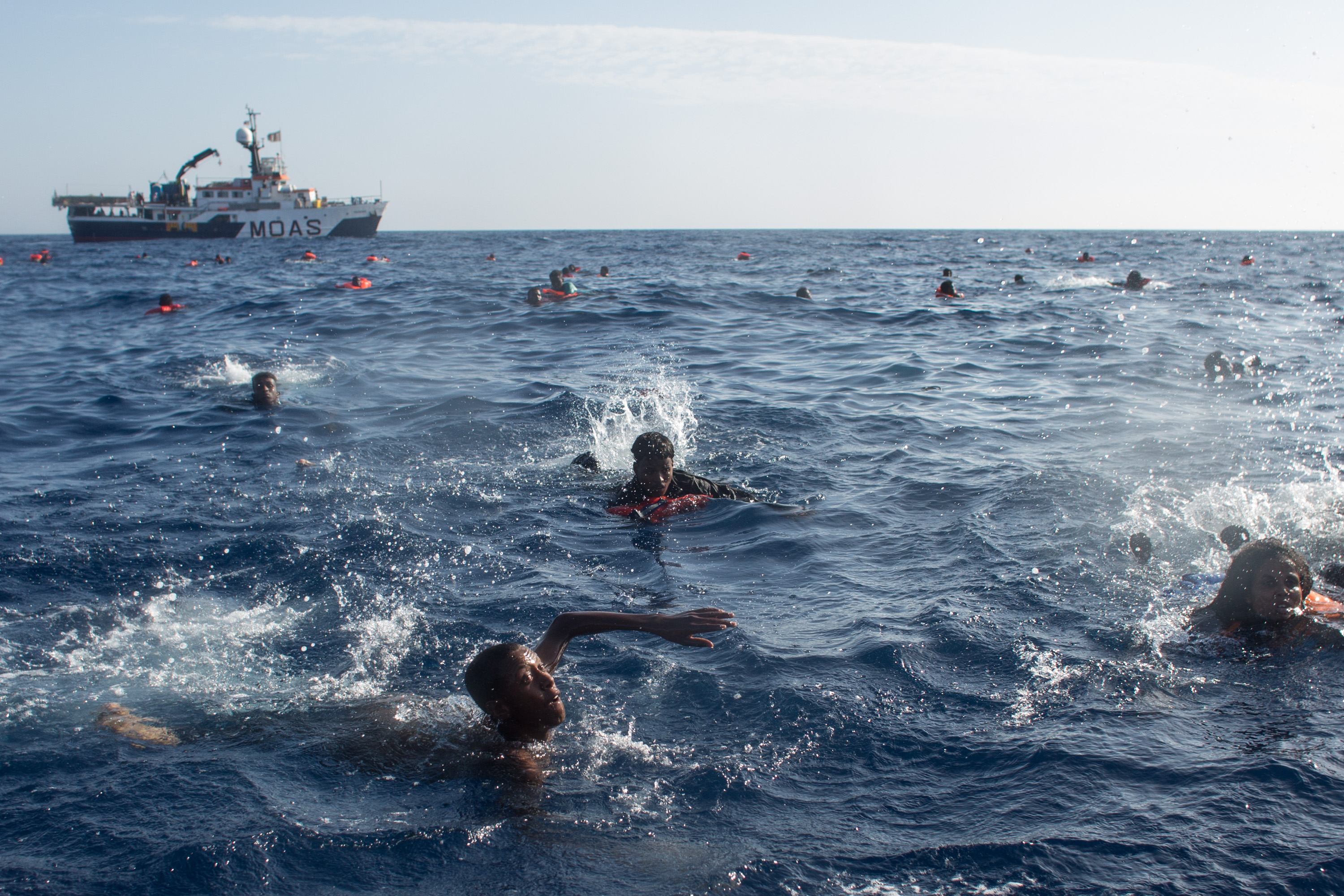 Refugees and migrants are seen swimming and yelling for assistance from crew members from the Migrant Offshore Aid Station (MOAS) 'Phoenix' vessel after a wooden boat bound for Italy carrying more than 500 people capsized on May 24, 2017 off Lampedusa, Italy. (Photo by Chris McGrath/Getty Images)