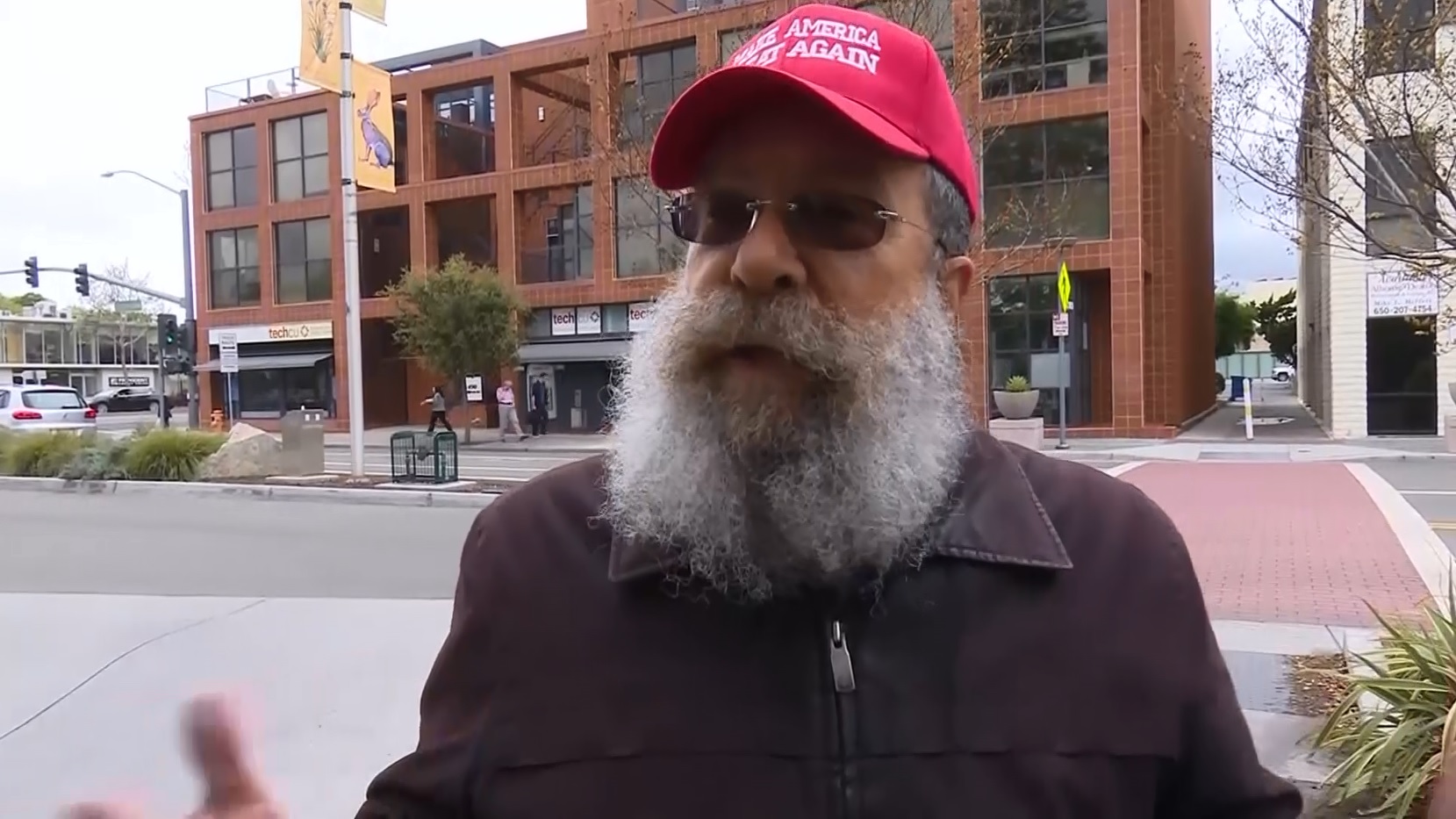 Victor F., a supporter of President Donald Trump, wears his "Make America Great Again" hat in Palo Alto following a confrontation at a local Starbucks. (CBS)