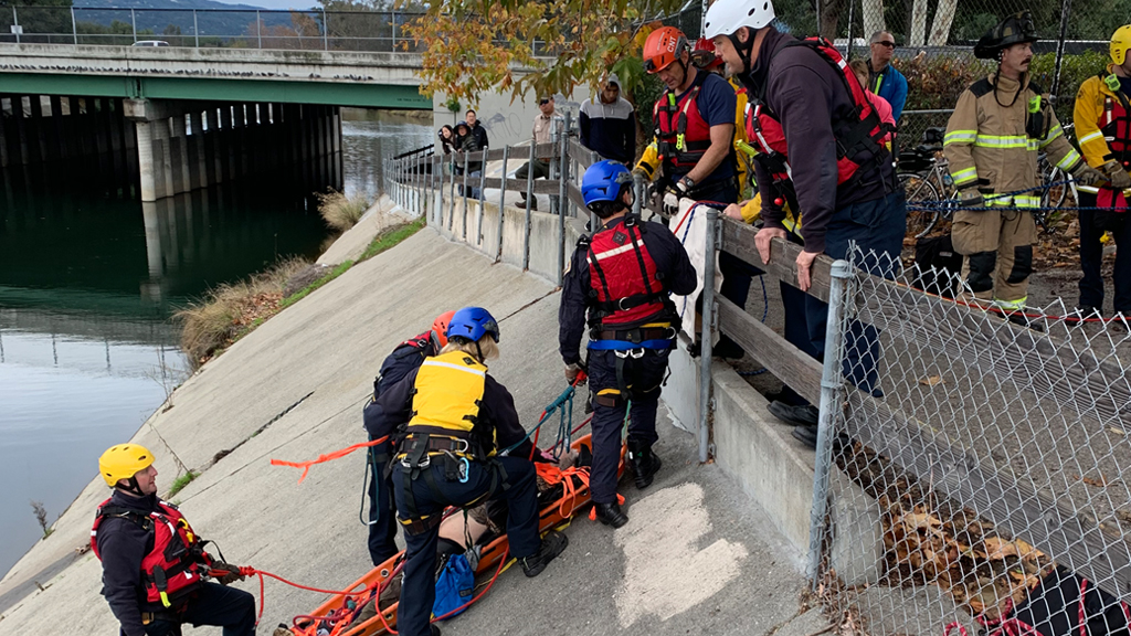 Rescuers pull a man to safety after he went into Los Gatos Creek in Campbell on Christmas Day, December 25, 2019. (Santa Clara County Fire Department)