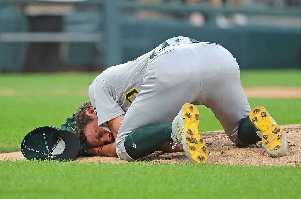 Starting pitcher Chris Bassitt #40 of the Oakland Athletics lies on the ground after being hit in the head by a line drive from Brian Goodwin of the Chicago White Sox in the second inning at Guaranteed Rate Field on August 17, 2021 in Chicago, Illinois. (Photo by Jonathan Daniel/Getty Images)
