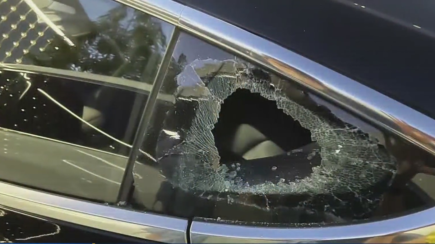 A broken window on a Tesla Model 3. (CBS)