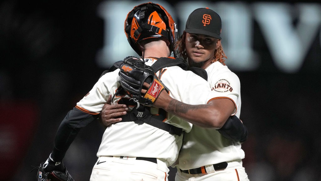 Camilo Doval #75 and Buster Posey #28 of the San Francisco Giants celebrate after defeating the Arizona Diamondbacks 1-0 at Oracle Park on September 29, 2021 in San Francisco. (Thearon W. Henderson/Getty Images)