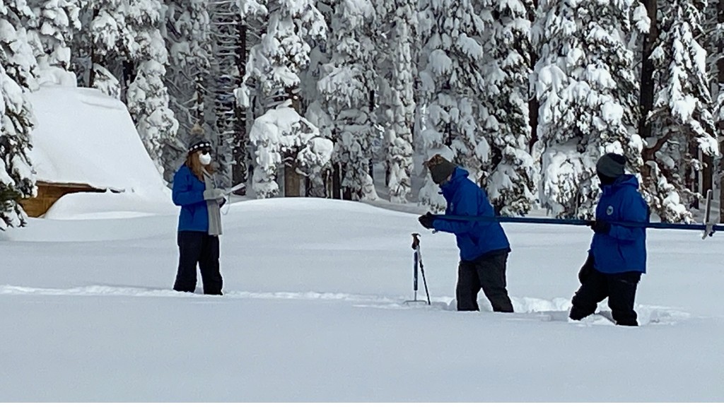 Officials with the Department of Water Resources conducting a snowpack survey at Phillips Station on December 30, 2021. (California Department of Water Resources)